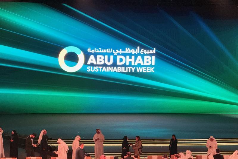 Abu Dhabi Sustainability Week logo on a wide LED wall above the audience