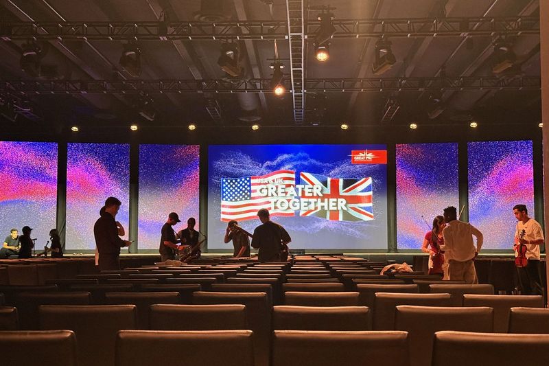 Greater Together LED wall with US and UK flags as the audience takes their seats, Los Angeles